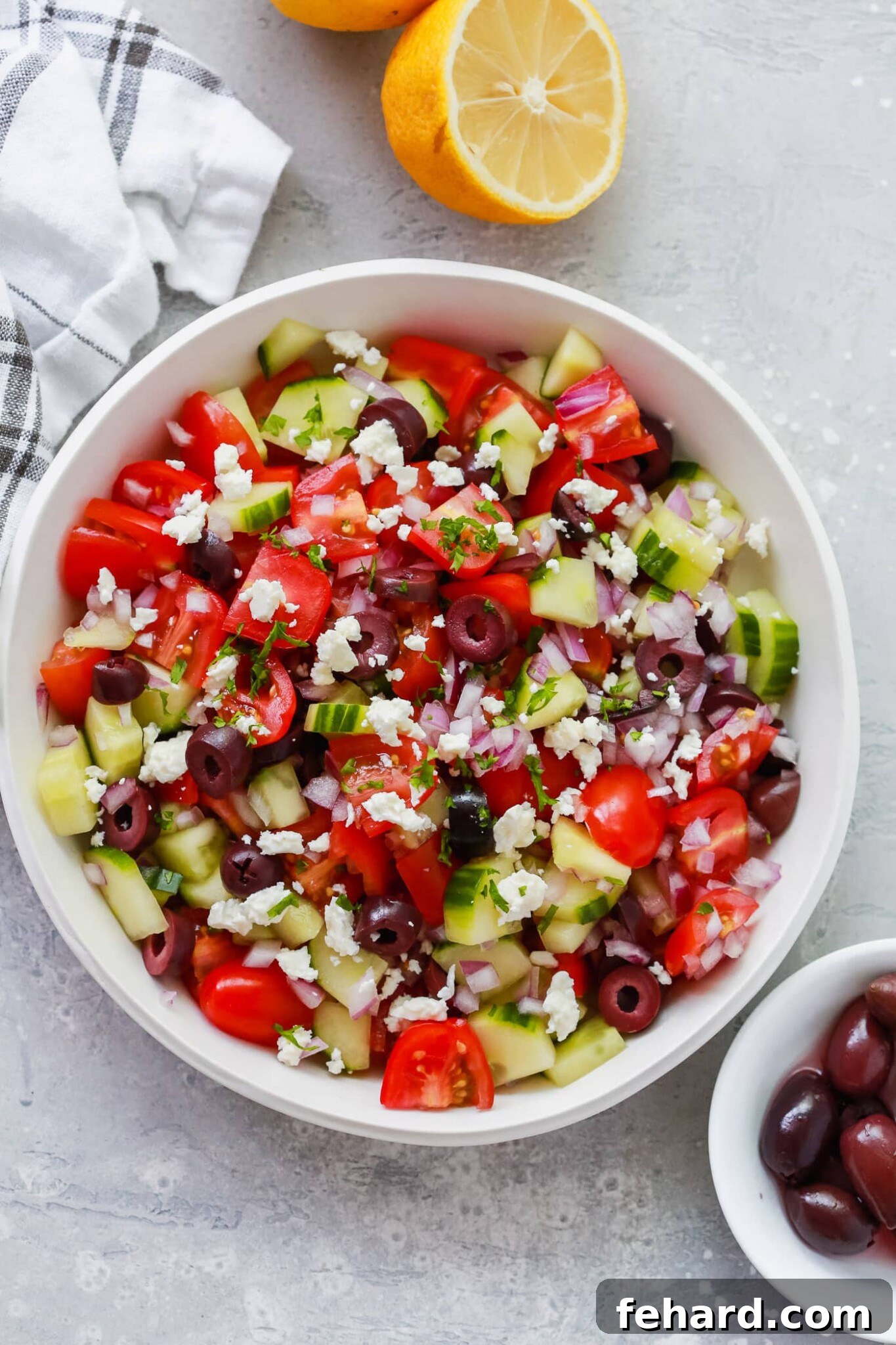 Overhead view of a vibrant Mediterranean salad on a white plate, perfect for a light and refreshing picnic.