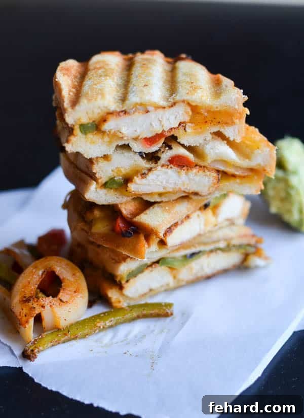 A delicious stack of chicken fajita grilled cheese sandwiches, cut in half and ready for a picnic.