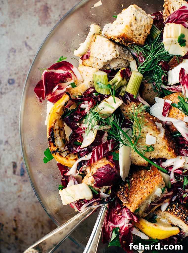 A bowl of vibrant roasted fennel panzanella, a hearty and flavorful picnic salad.