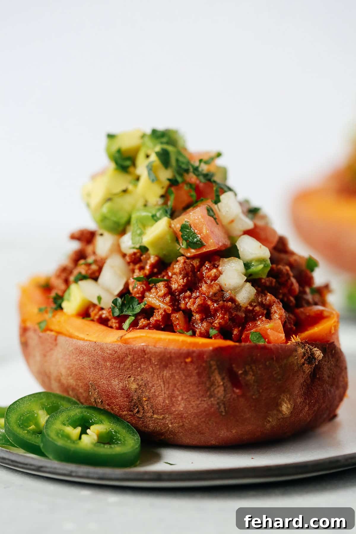 Sweet Potato Taco Boats 3 Close-up of a perfectly baked sweet potato filled with savory taco meat and fresh salsa
