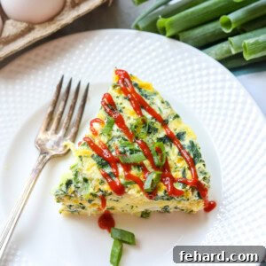 Slice of Spinach Egg Frittata on white plate