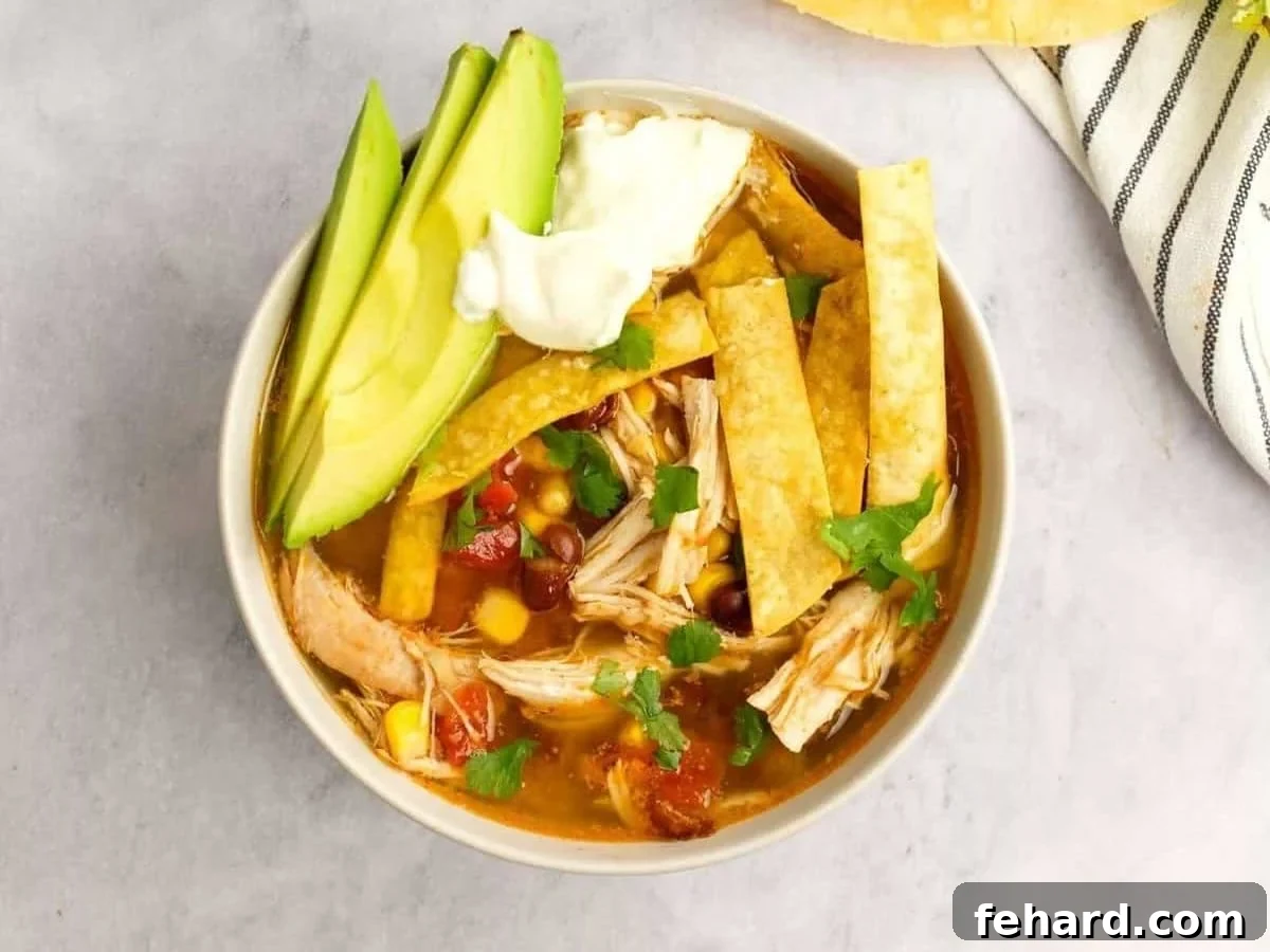 Instapot Chicken Tortilla Soup Bowl of Instant Pot Chicken Tortilla Soup topped with avocado, lime, and tortilla strips.