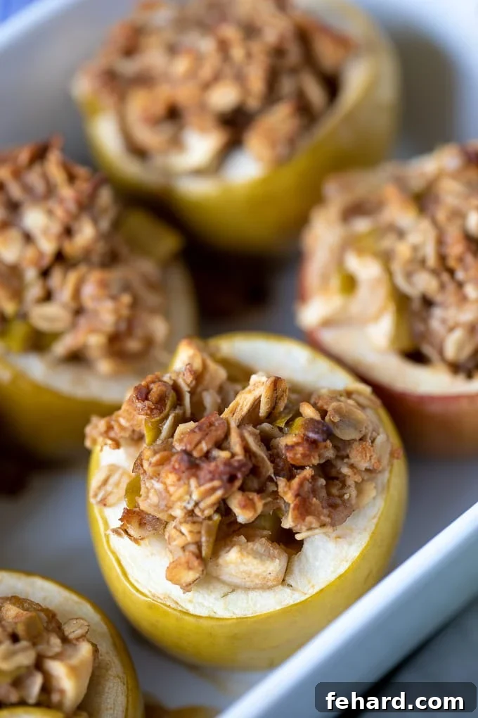 Baking dish with golden brown baked apples, steam gently rising