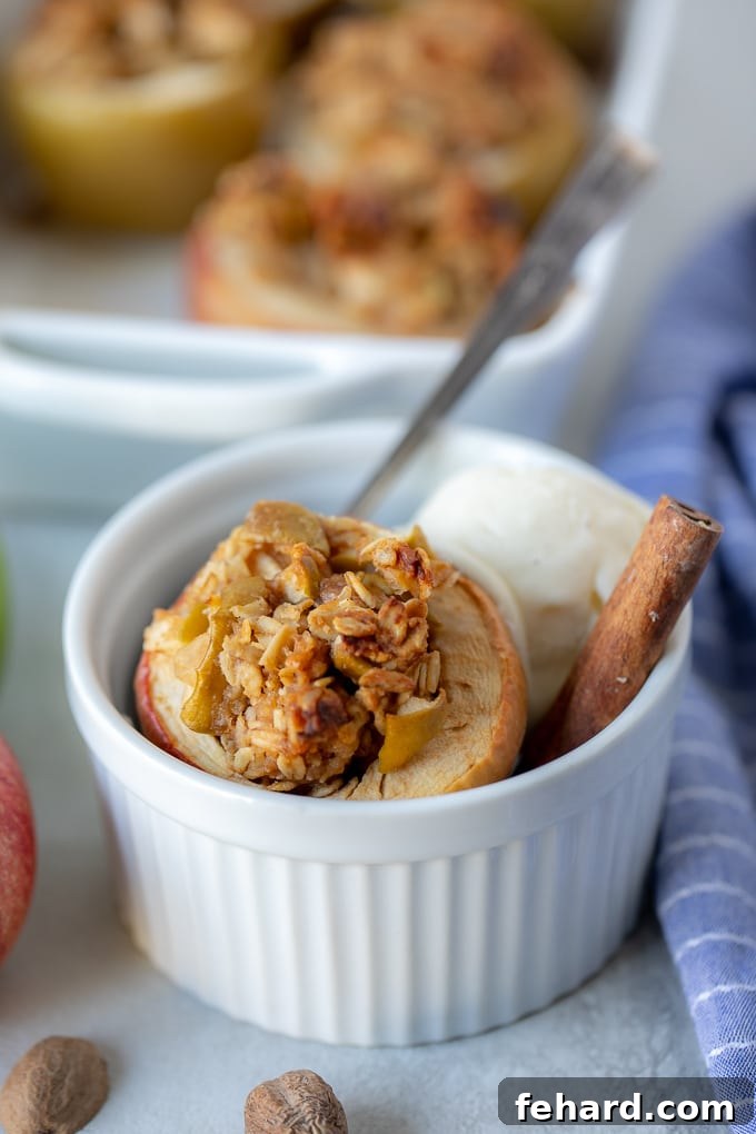 Baked Apple with melting vanilla ice cream in a white dish, ready to be eaten