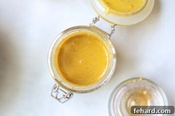 Champagne Vinaigrette in small glass mixing jar with lid.