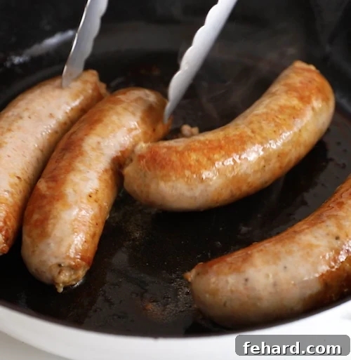 sautéed italian sausage in a cast iron skillet