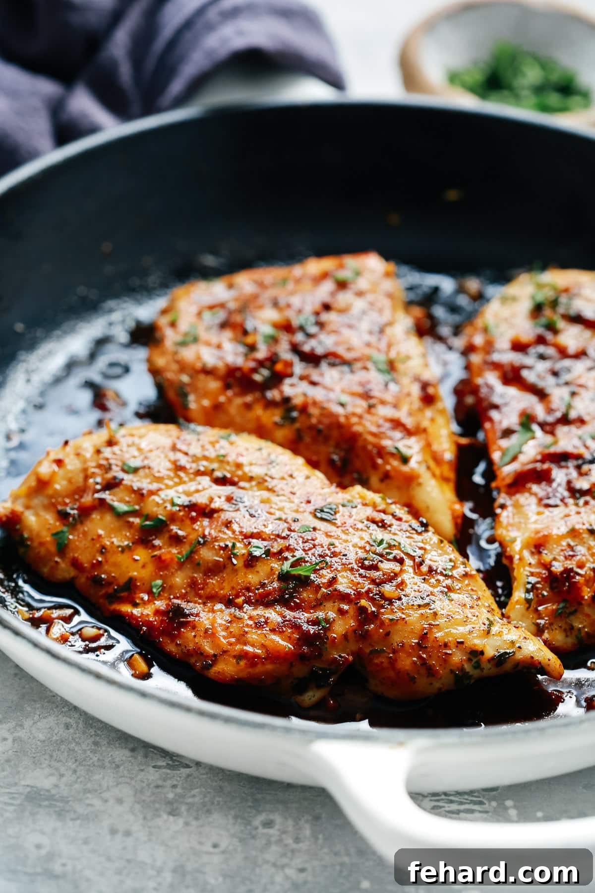 Closeup view of a cast iron skillet filled with cooked chicken