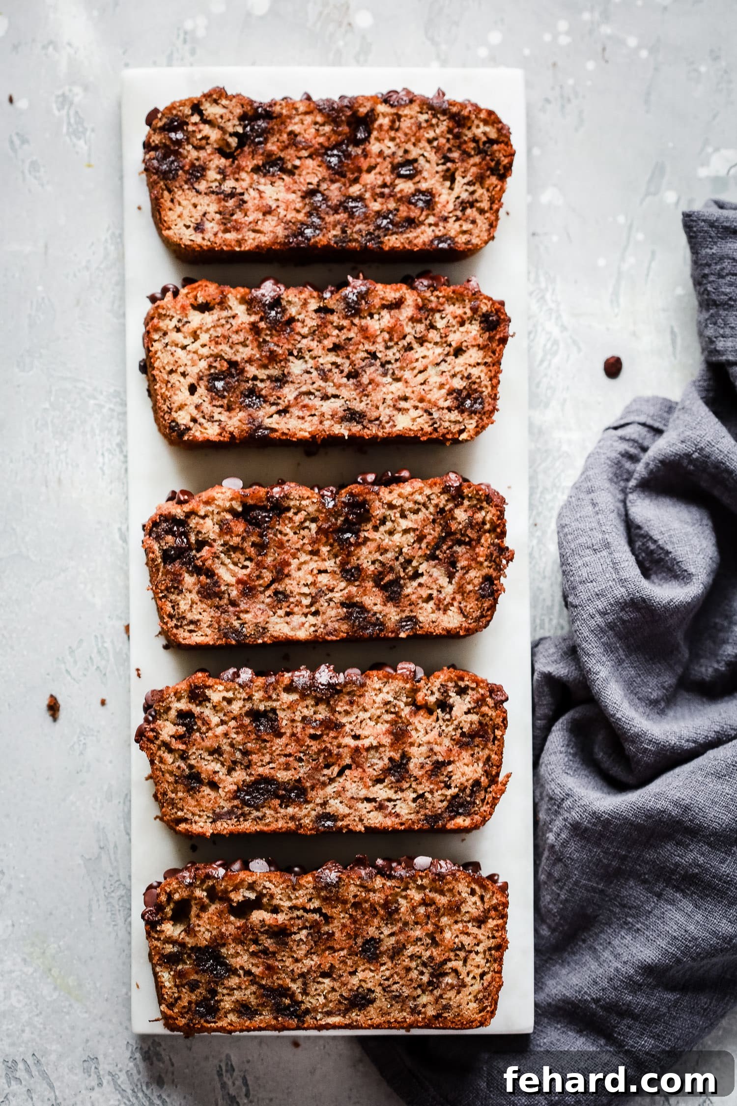 Close-up of a slice of Paleo Chocolate Chips Almond Flour Banana Bread showing its moist texture and chocolate chips.