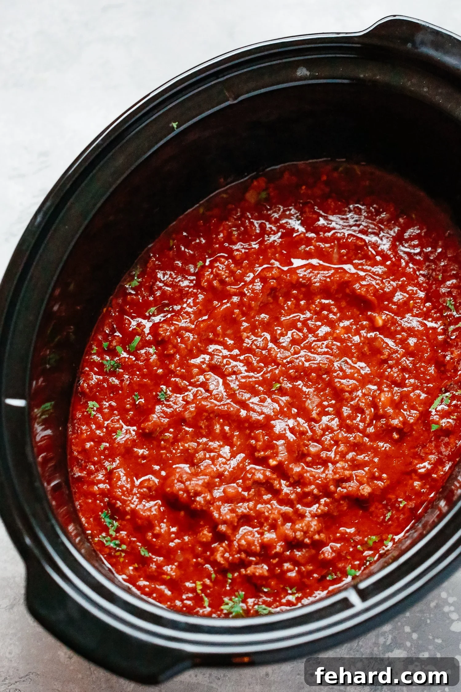 Close-up of freshly made homemade meat sauce, showcasing its rich texture and appetizing appeal.