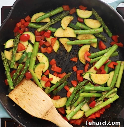 Skillet with colorful vegetables cooking