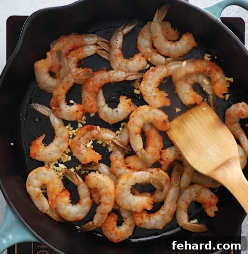 overhead view of cast iron skillet containing shrimp and sausage