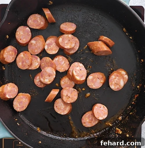 overhead view of a cast iron skillet containing sausage