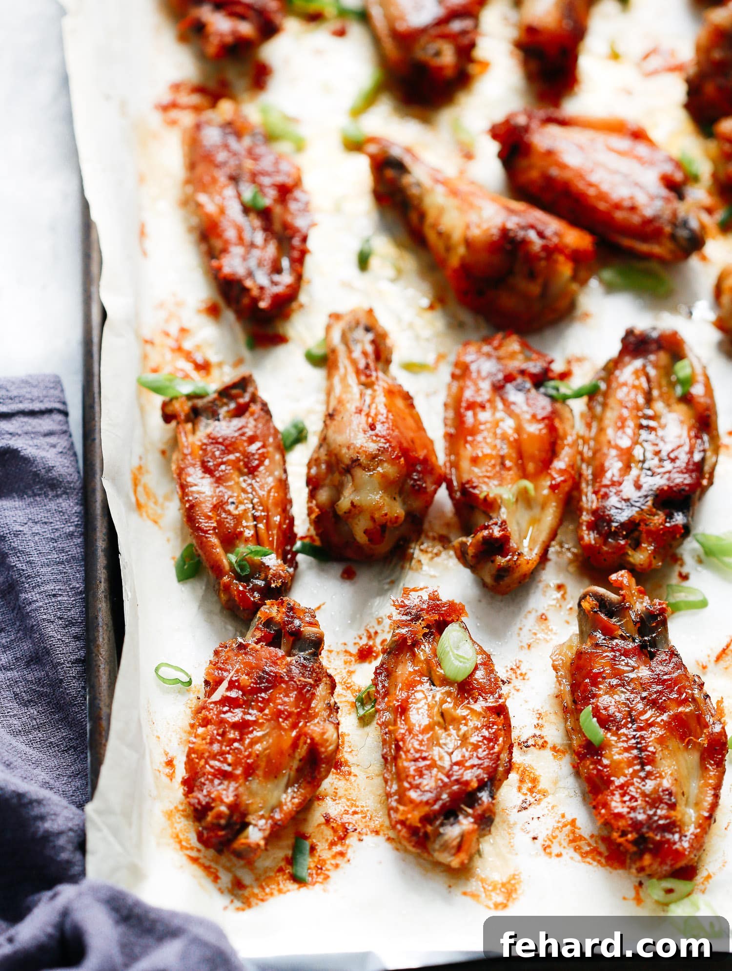 Close-up of baked chicken wings on a baking sheet