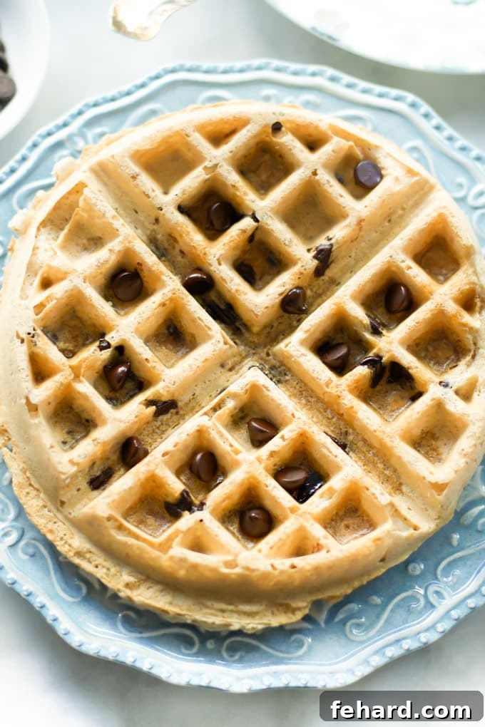 Close up of an almond butter waffle with chocolate chips.