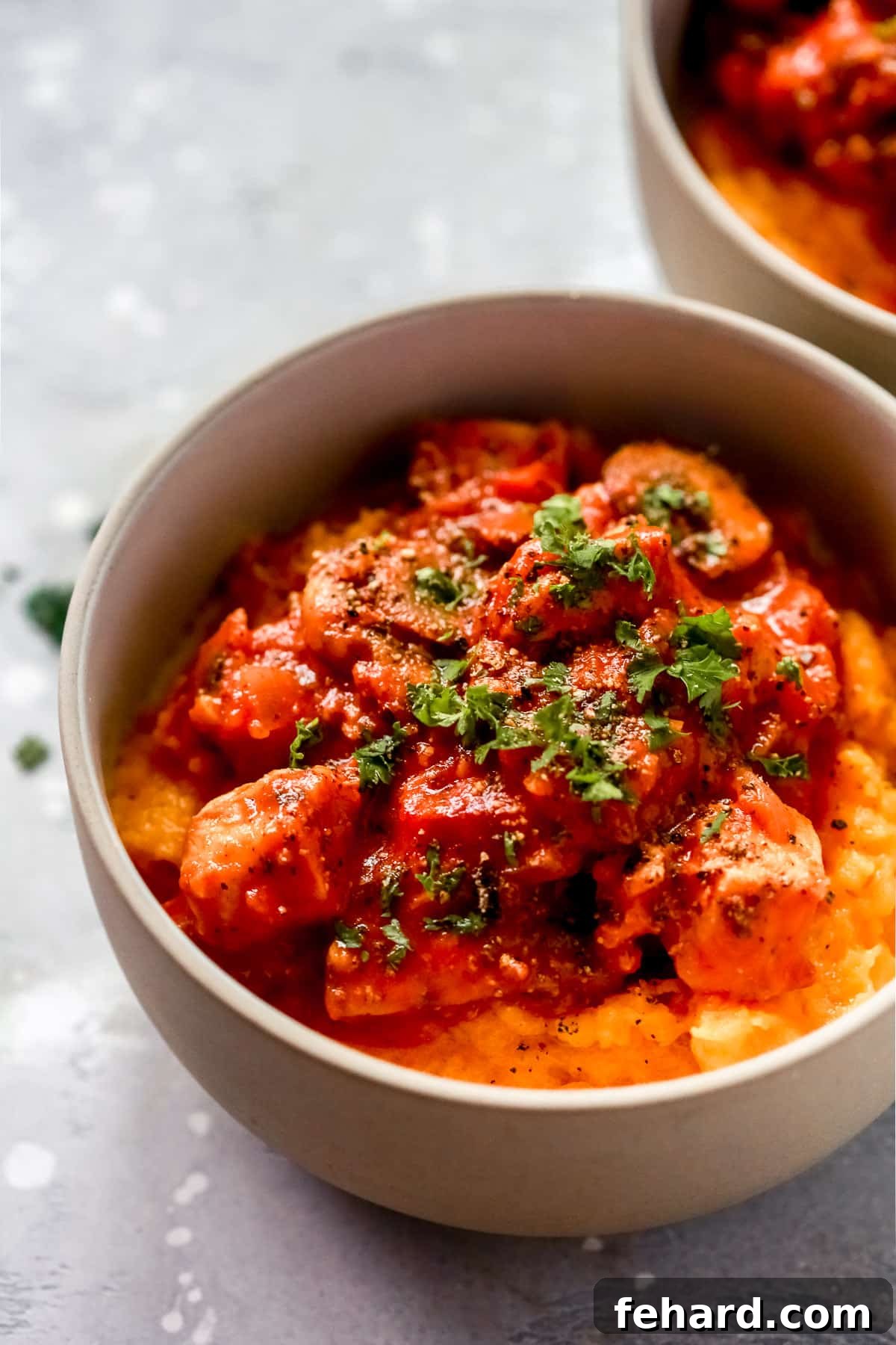 Chicken stroganoff with butternut squash mash served in cozy individual bowls, garnished with fresh herbs.
