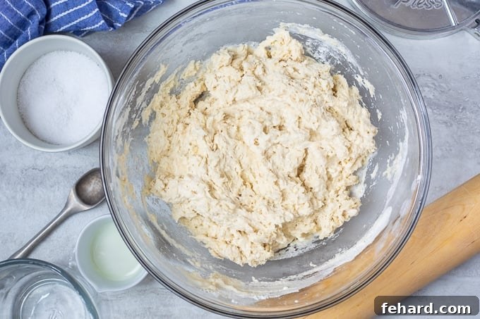 Tortilla dough mixture in a glass bowl, just after combining ingredients.