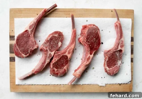 raw lamb chops on a wooden board