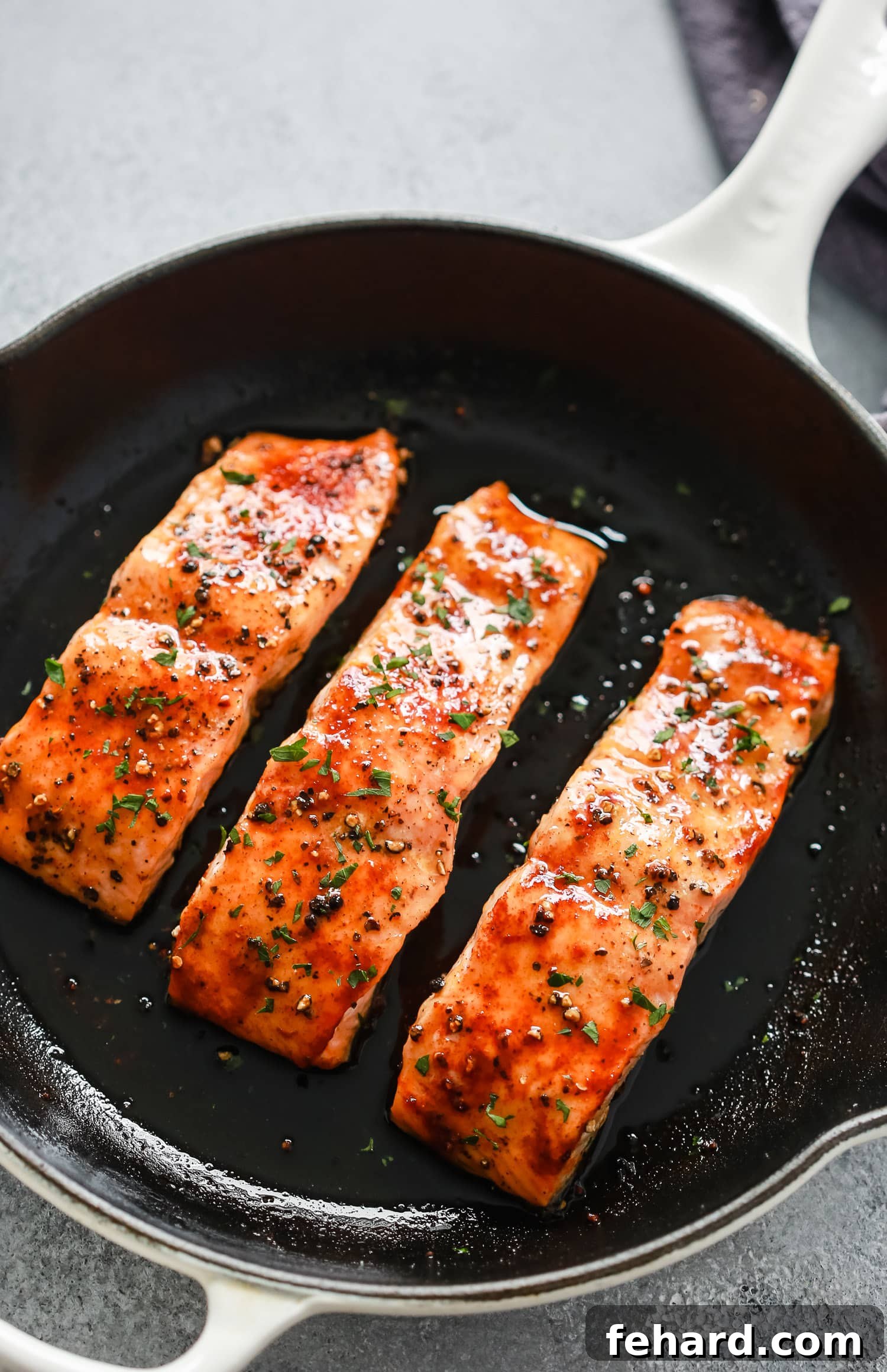 Frozen salmon thawing on a plate in the refrigerator