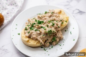 Rich Country Sausage Gravy 9 Sausage Gravy served over buttermilk biscuits topped with parsley.
