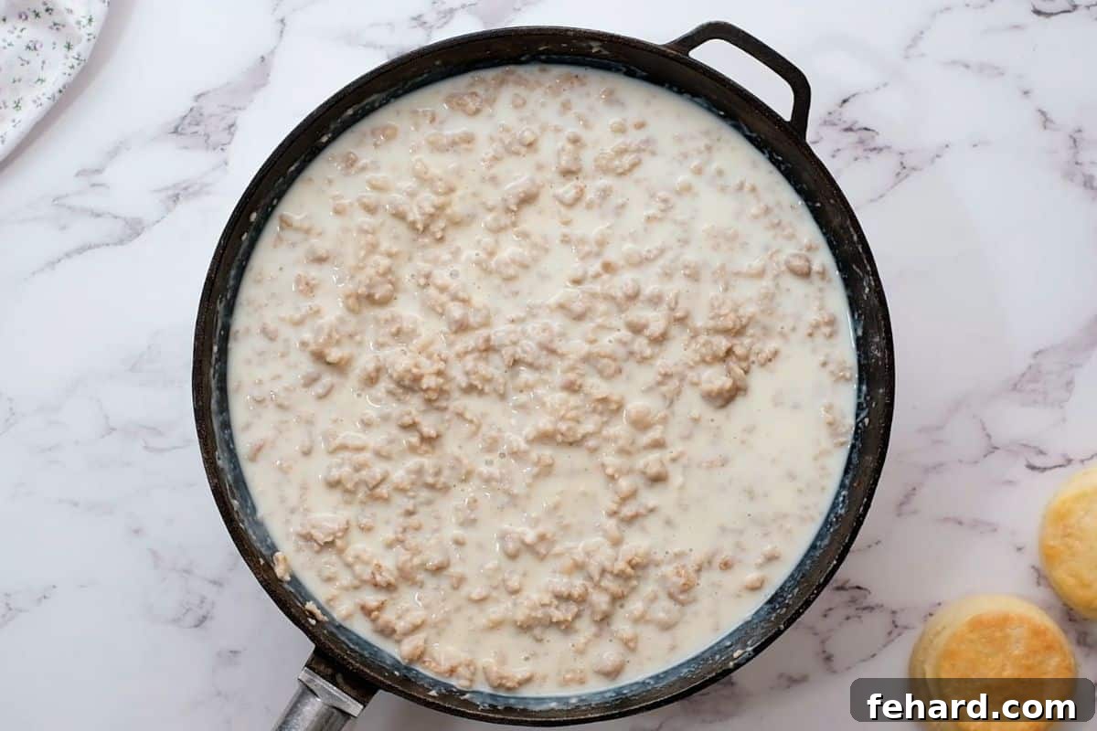 Gravy Before Thickening Sausage gravy mixture in a skillet, before simmering to thicken.