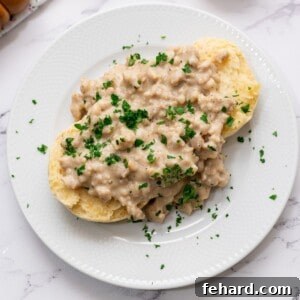 Sausage Gravy served over buttermilk biscuits topped with fresh parsley.