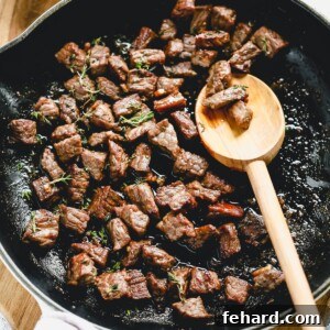 Garlic Butter Steak Bites cooking in a skillet, showcasing a quick and easy weeknight meal.