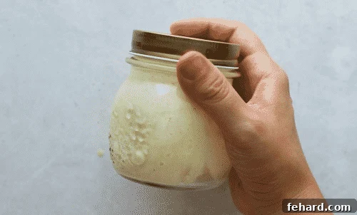 Overhead view of a mason jar containing broccoli salad dressing