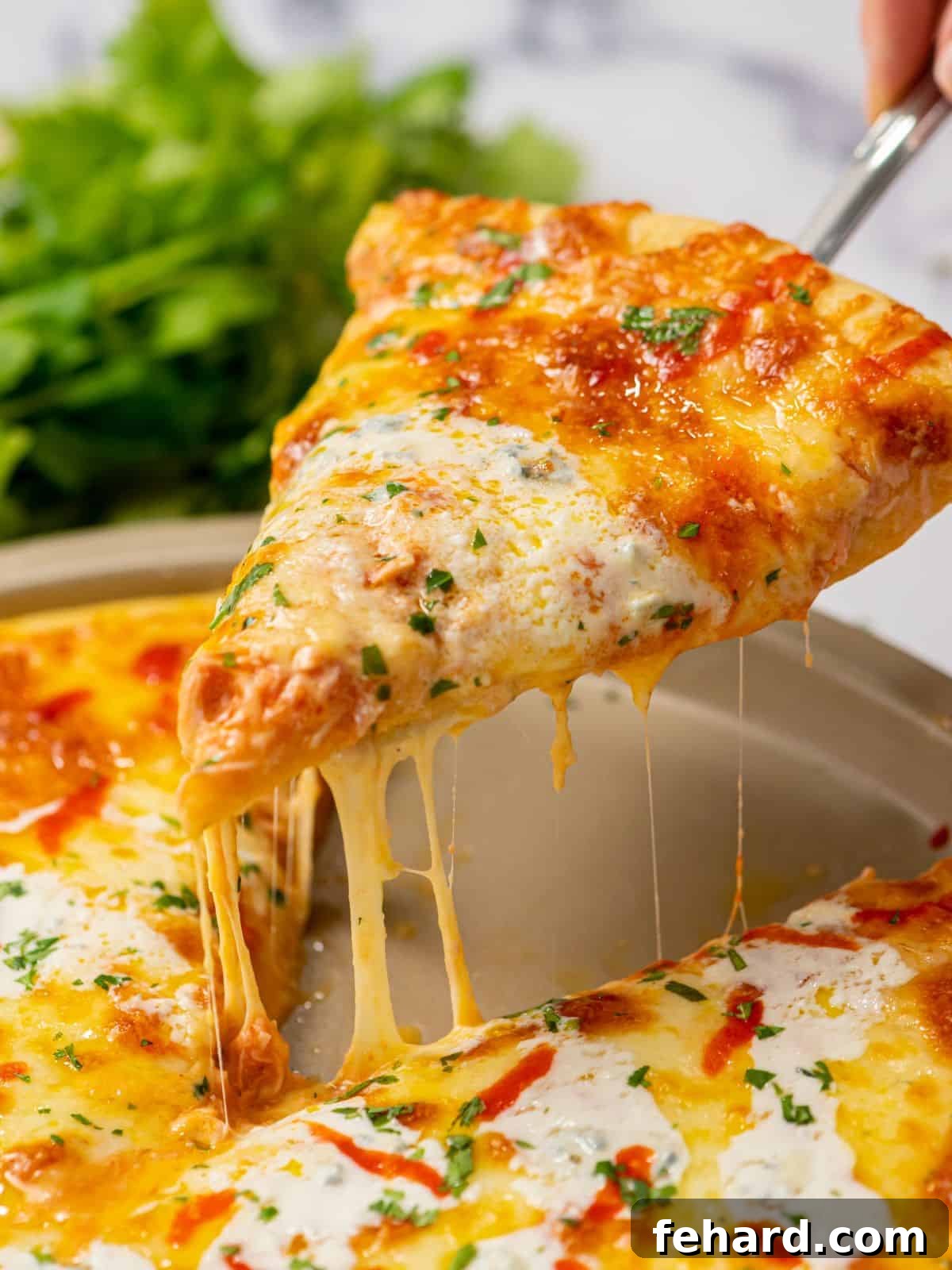 Buffalo Chicken Pizza Recipe - Easy Homemade Spicy Pizza A delectable slice of homemade Buffalo chicken pizza being lifted from the pan, showcasing a glorious cheese pull and perfectly browned crust.