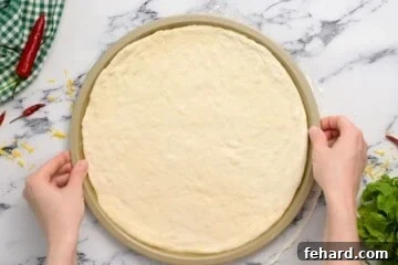 Hot Wing Pizza 6 Pizza dough shaped to fit 12-inch pizza pan.