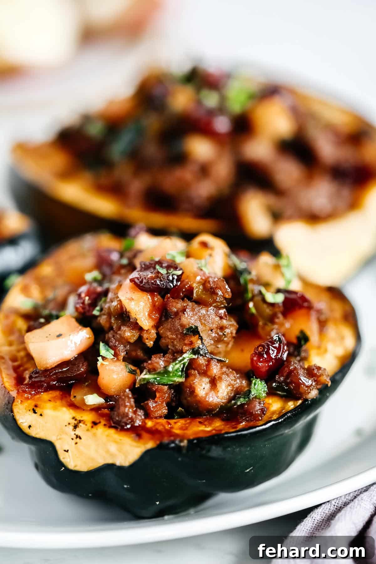 Hearty Sausage-Filled Acorn Squash Bake 8 A close-up view of the finished Sausage Stuffed Acorn Squash, garnished with fresh herbs and ready to serve.