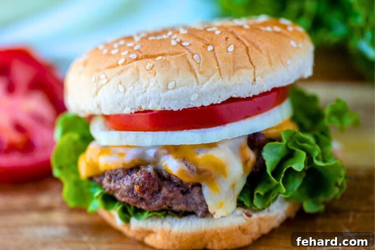 A beautiful homemade burger on a cutting board, nestled in a toasted bun and topped with fresh lettuce and ripe tomatoes, ready to be enjoyed.