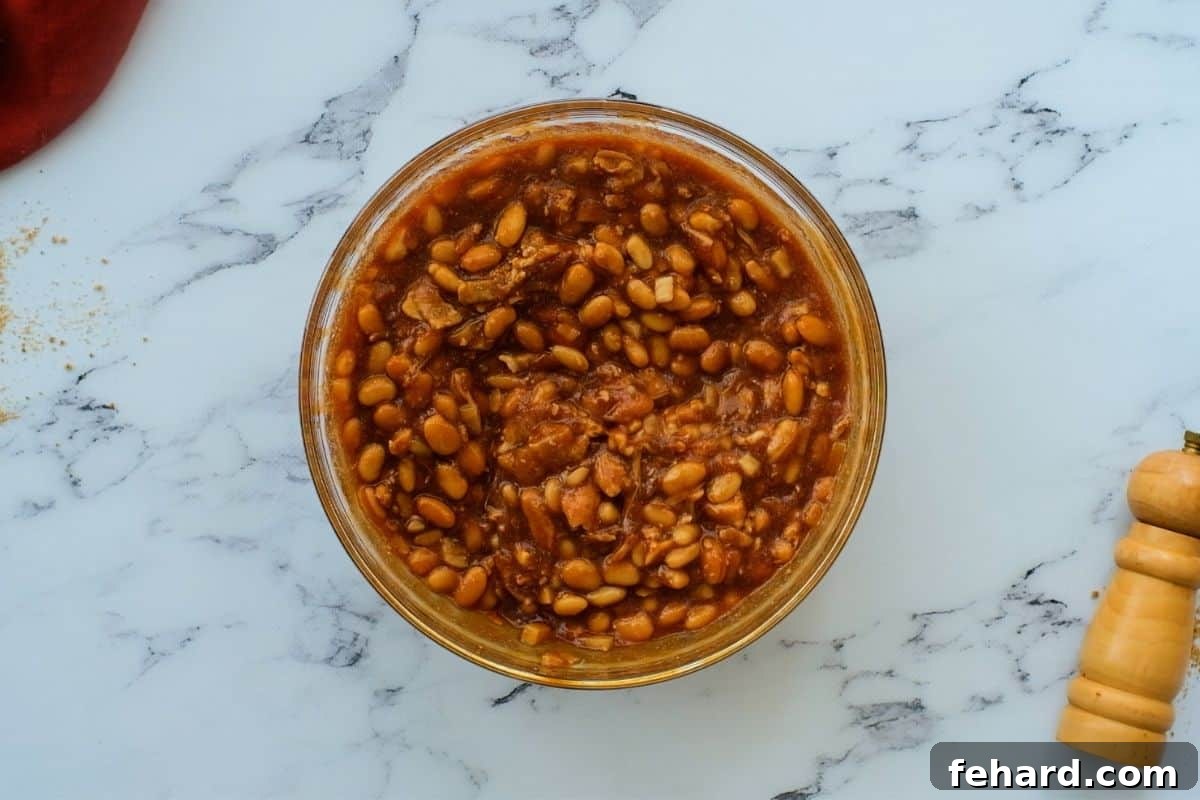 Cooked beans mixed with a rich sauce of molasses, brown sugar, and bacon.