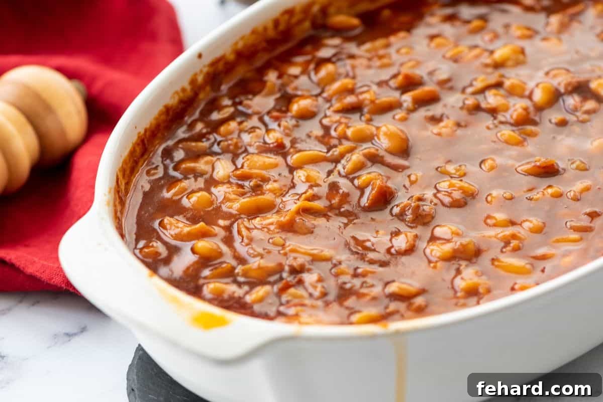 Baked Beans in a large white casserole dish, fresh out of the oven.