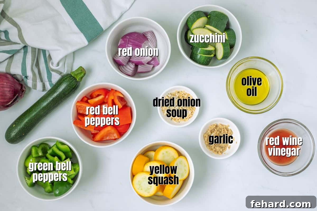 A collection of fresh ingredients laid out on a kitchen counter, including various bell peppers, zucchini, onions, olive oil, red wine vinegar, and dry onion soup mix, all prepared for making easy veggie kabobs.