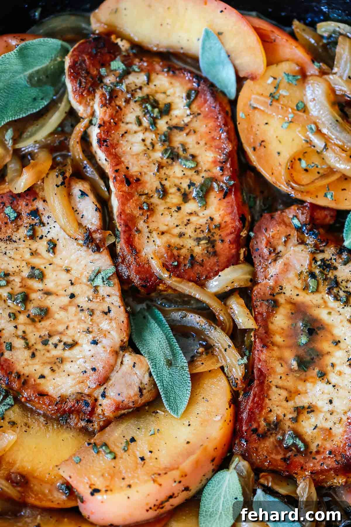 Perfectly seared boneless pork chops, golden brown and juicy, ready to be combined with apples and onions.