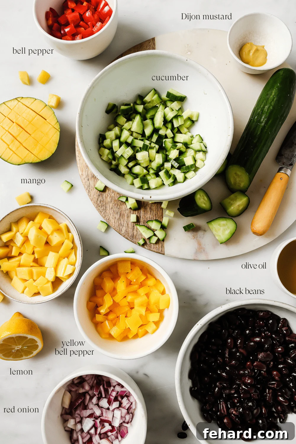 Small bowls containing pre-measured, diced ingredients like black beans, mango, cucumber, and bell peppers, ready for mixing.