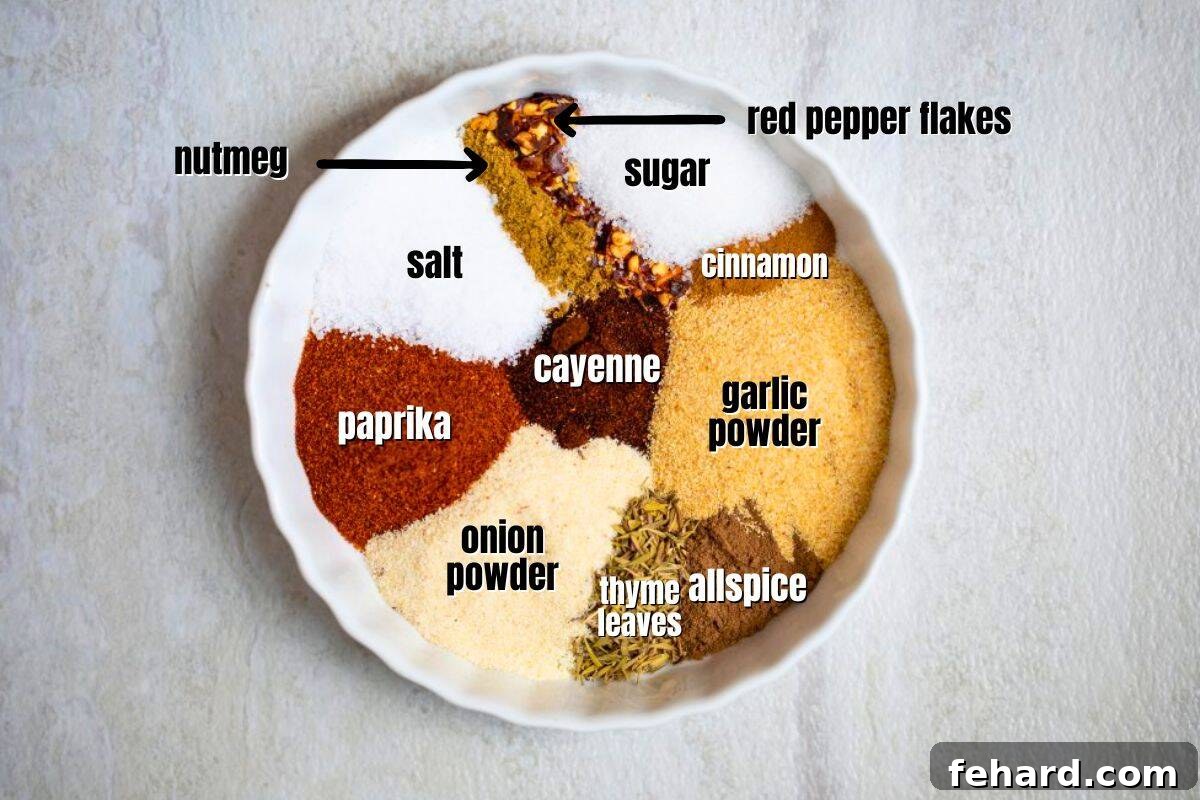 A collection of spices including sugar, salt, onion powder, garlic powder, thyme leaves, allspice, red pepper flakes, cinnamon, nutmeg, paprika, and cayenne, arranged in dishes for homemade Jerk seasoning.