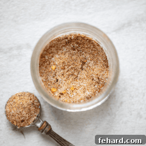 Jar of Jamaican Jerk Seasoning next to a teaspoon.