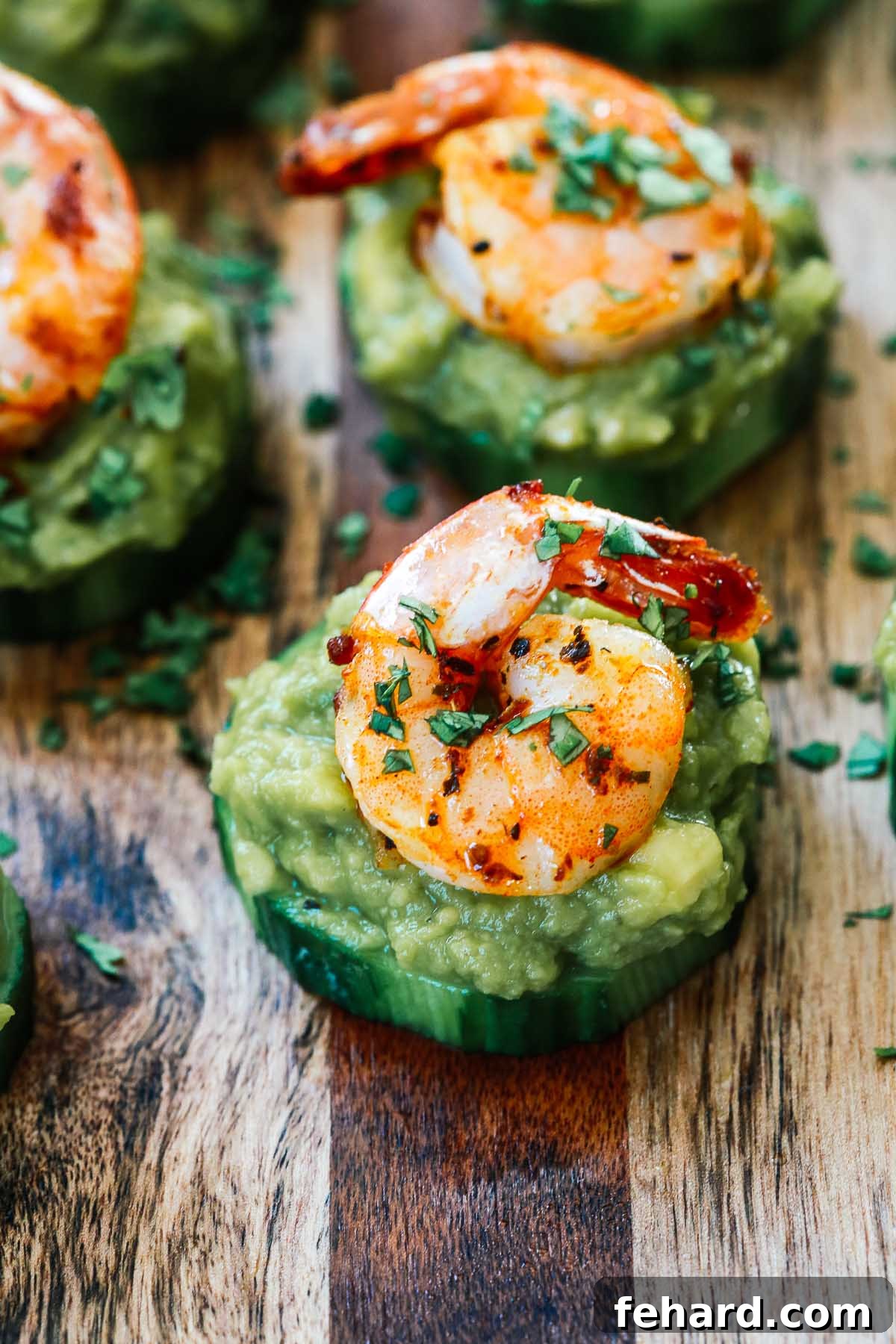 Irresistible Shrimp Guacamole Poppers 4 Slices of cucumber topped with guacamole and shrimp