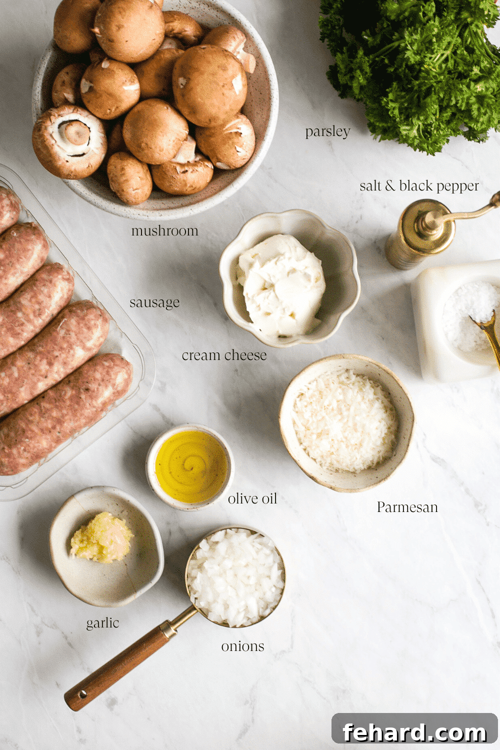 Overhead view of all the fresh ingredients laid out to make Sausage Stuffed Mushrooms on a rustic wooden surface.