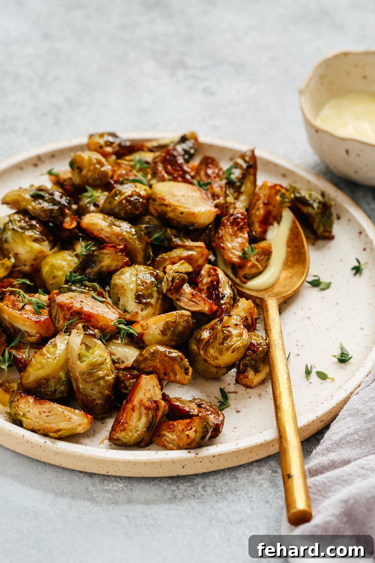 Crispy Brussels Sprouts with Tangy Mustard Mayo 3 Close-up photo of a roasting pan filled with golden-brown roasted Brussels sprouts, highlighting their perfectly crispy and tender texture.