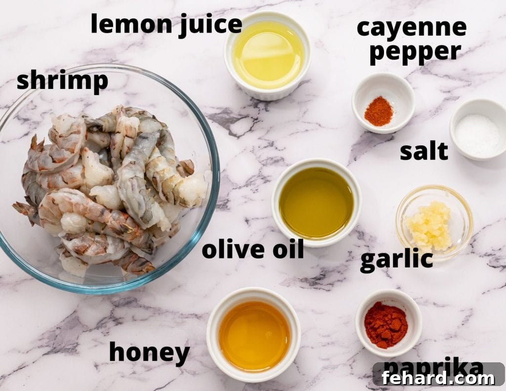 Labeled ingredients for honey garlic shrimp: olive oil, lemon, garlic, honey, salt, cayenne, paprika, and raw shrimp.