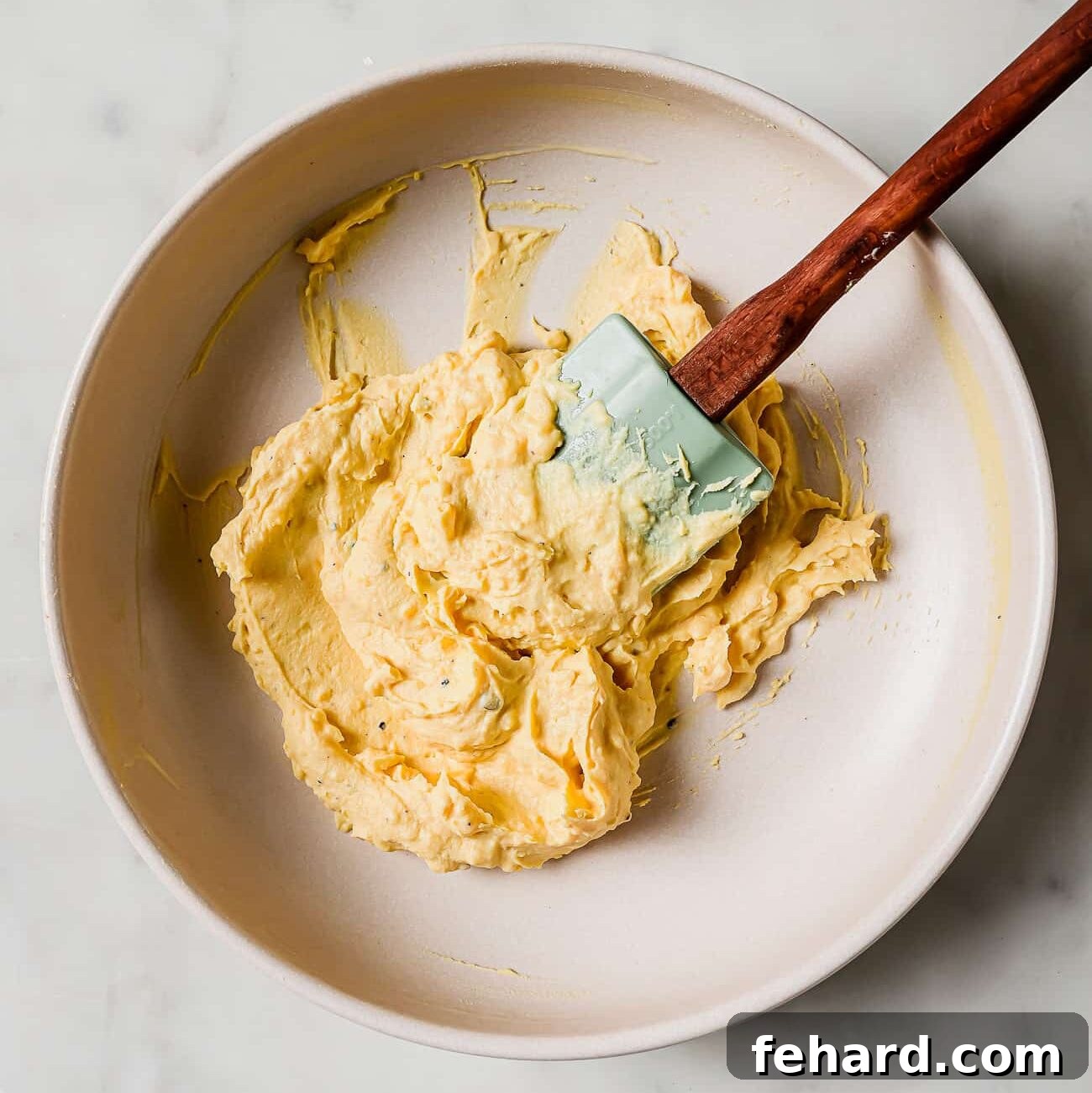 A bowl filled with the creamy, mashed egg yolk mixture, perfectly blended and ready to be piped back into the egg whites.