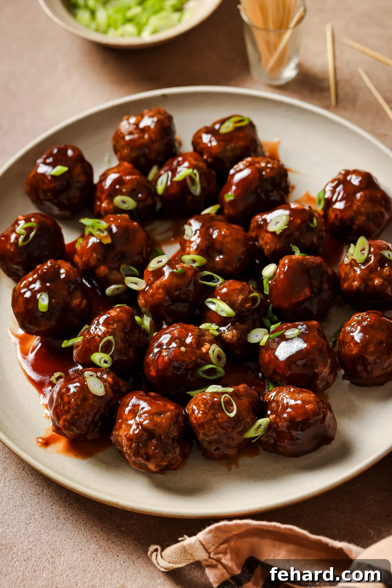 Irresistible Party Meatballs 2 cocktail meatballs on a plate.