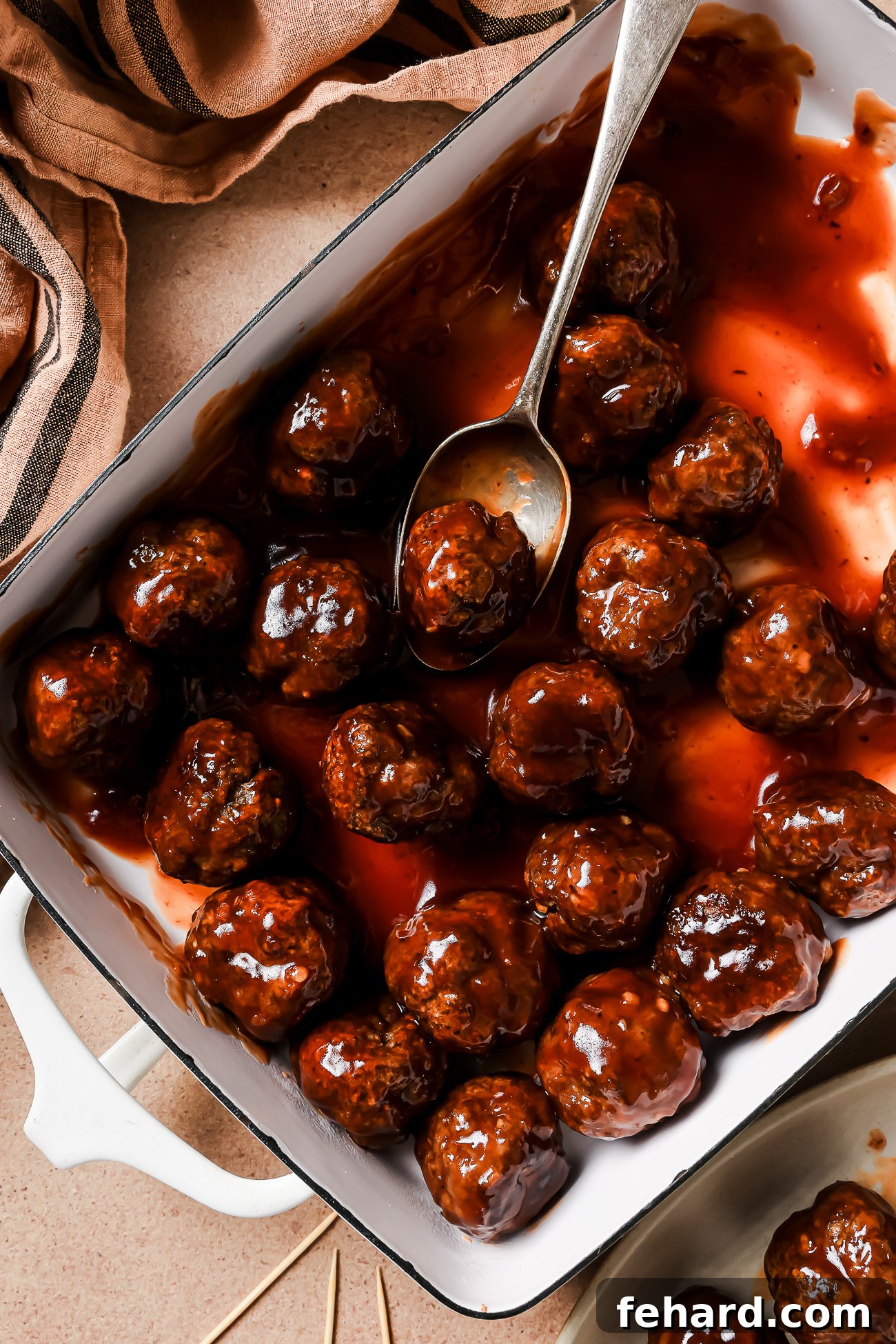 Irresistible Party Meatballs 11 Overhead view of cocktail meatballs in a casserole dish.