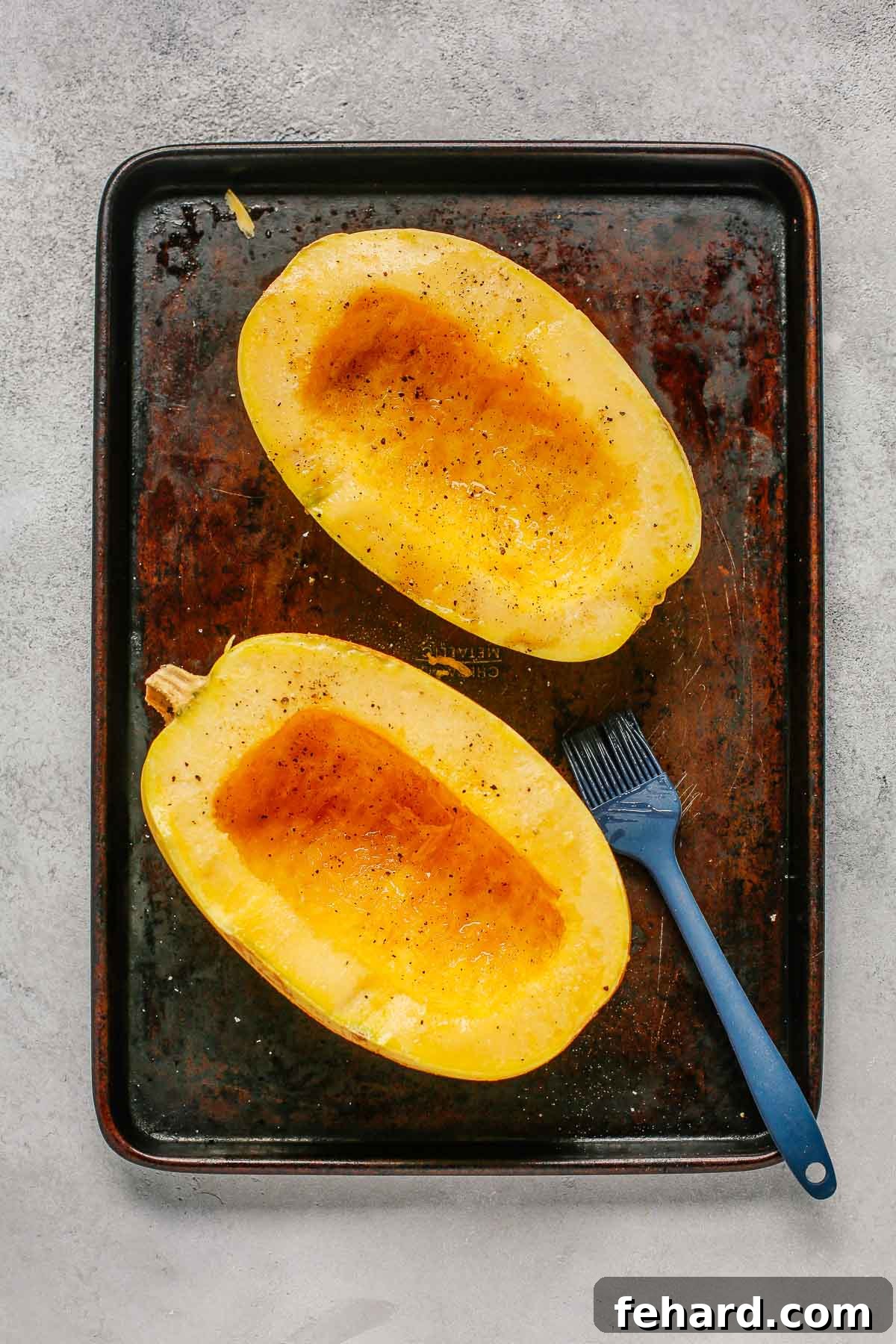 Spaghetti squash halves seasoned with olive oil, salt, and pepper