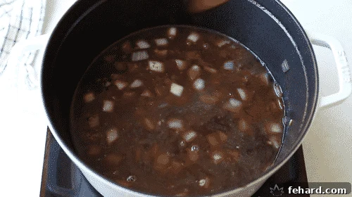 Tender Whole30 Pot Roast 10 overhead view of wine and beef stock in a Dutch oven pot