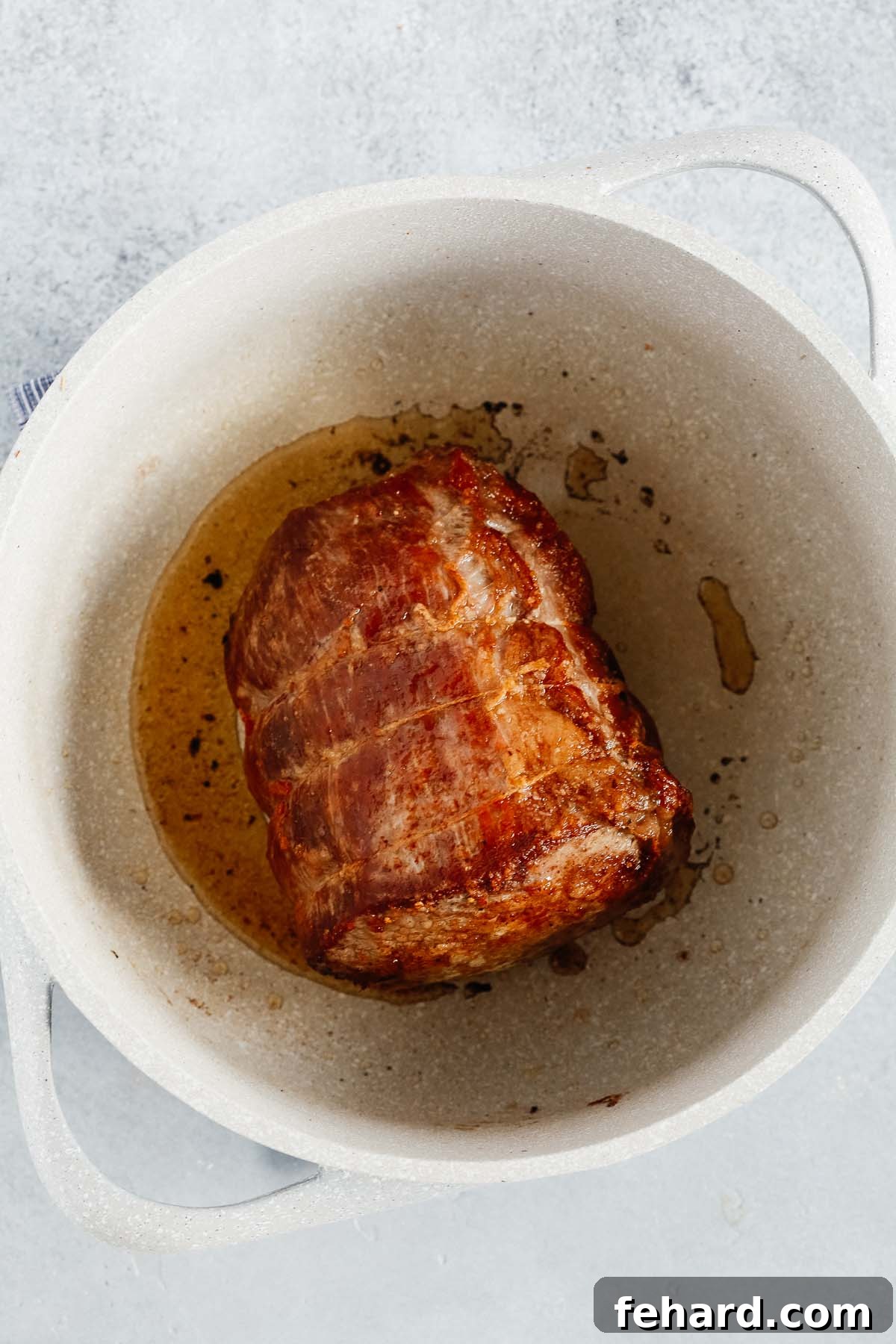 Tender Whole30 Pot Roast 3 overhead view of a large white pot containing seared Pot Roast