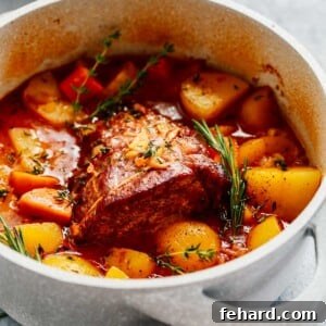 Tender Whole30 Pot Roast 5 close up of a large white pot containing Whole30 Pot Roast