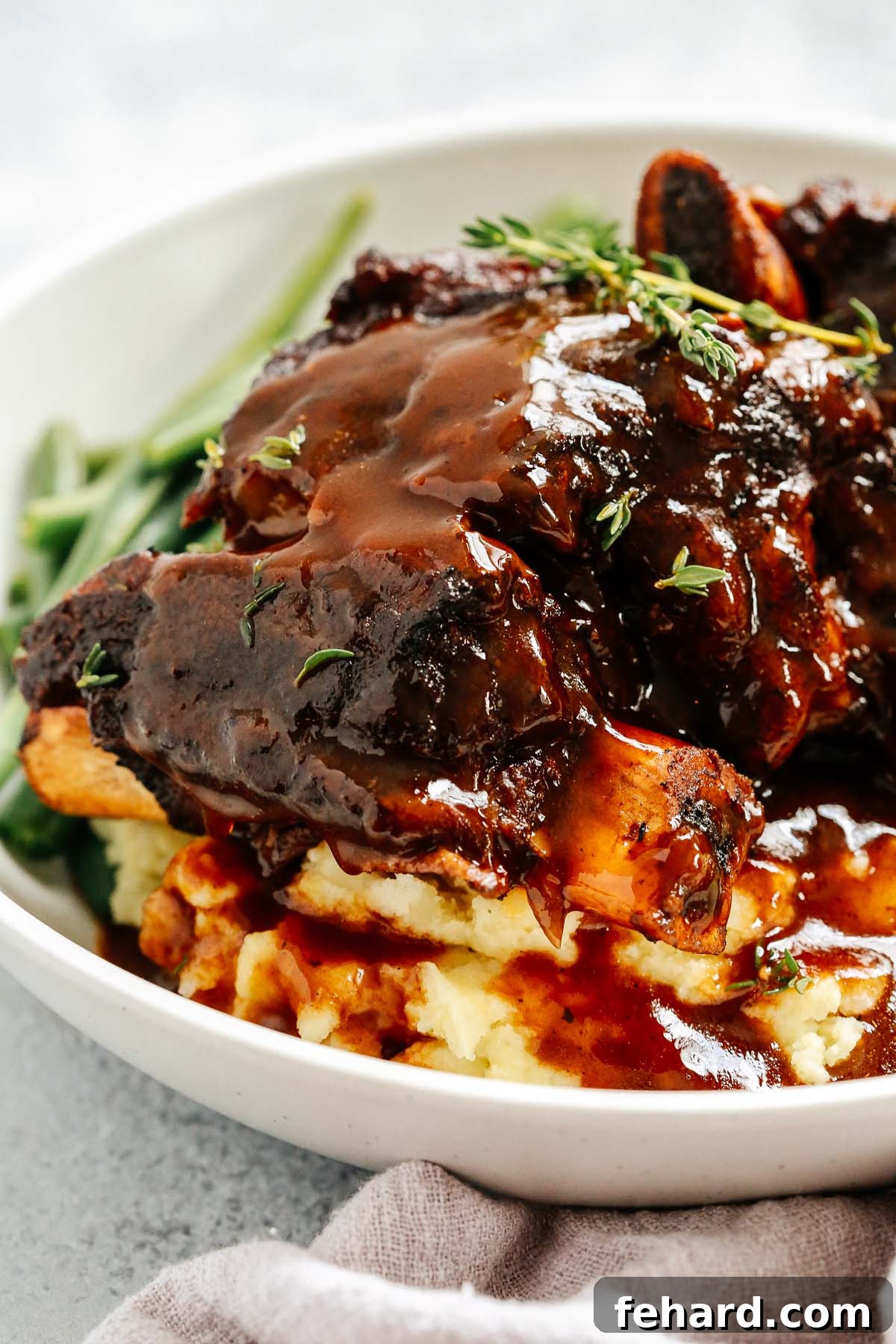 Instant Pot Short Ribs topped with a rich, glossy sauce and garnished with fresh parsley.